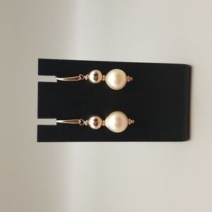 Rose gold tone metal and blush pearl earrings.